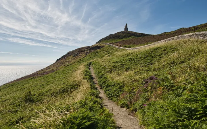 Looking up the Bradda Head path toward Milner’s Tower, Isle of Man (Photo Credit: Chris Rycroft • CC BY 2.0)